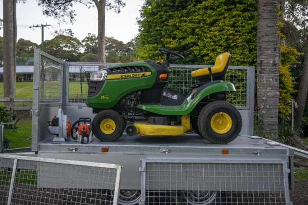 John Deere mower on Variant proline trailer with ramps and cage sides - gardeners best tools.