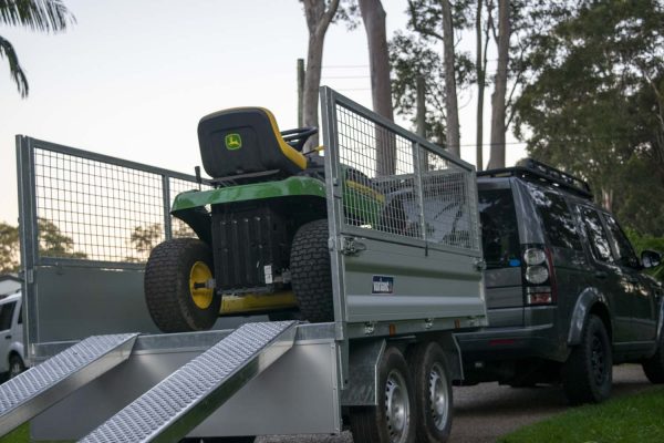 John Deere mower on Variant proline trailer with ramps and cage sides - gardeners best tools.