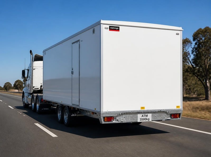 Scanvogn mobile office trailer with ATM 3500kg plate towed behind a large truck on an Australian highway (illustrative image)